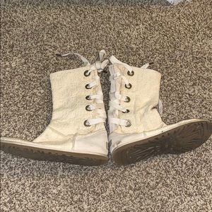 Beige UGG boots with laces on the back